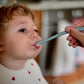 Kid being fed with a spoon