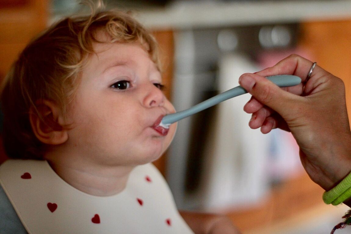 Kid being fed with a spoon